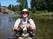 Gary with a Crowsnest River trout. In water as clear as this you are often "sight fishing" or first seeing fish and then casting to them.